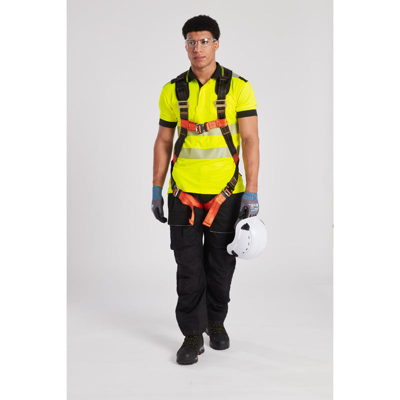 Worker in safety helmet and harness, preparing for high-altitude construction tasks.