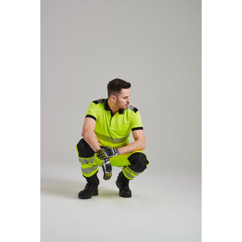 A team of two workers dressed in Portwest hi-vis safety gear.