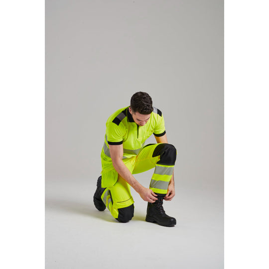Black safety boot shown with trousers, featuring waterproof design and high ankle protection