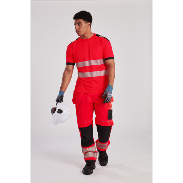 Man in a hi-vis t-shirt, work trousers, hard hat, and safety glasses on a work site.
