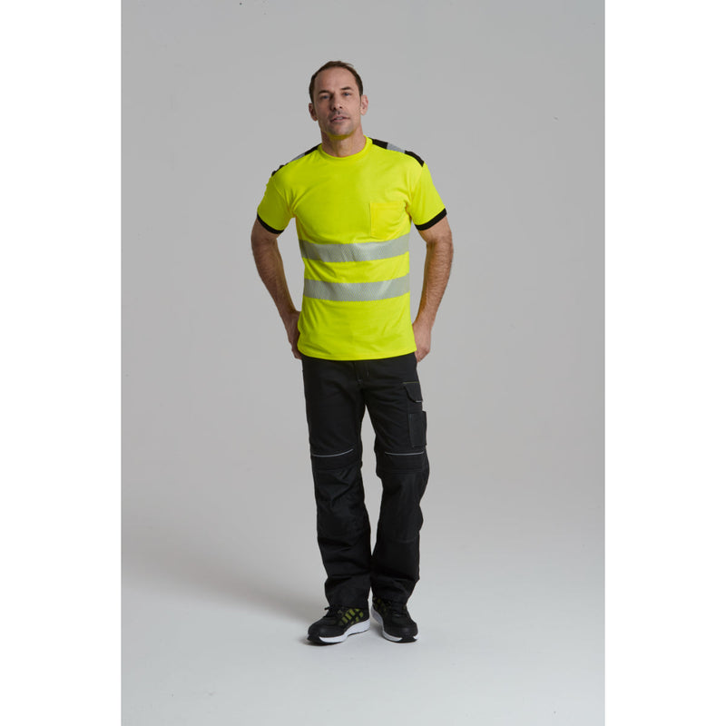 A worker inserting a knee pad into the Portwest work trousers.
