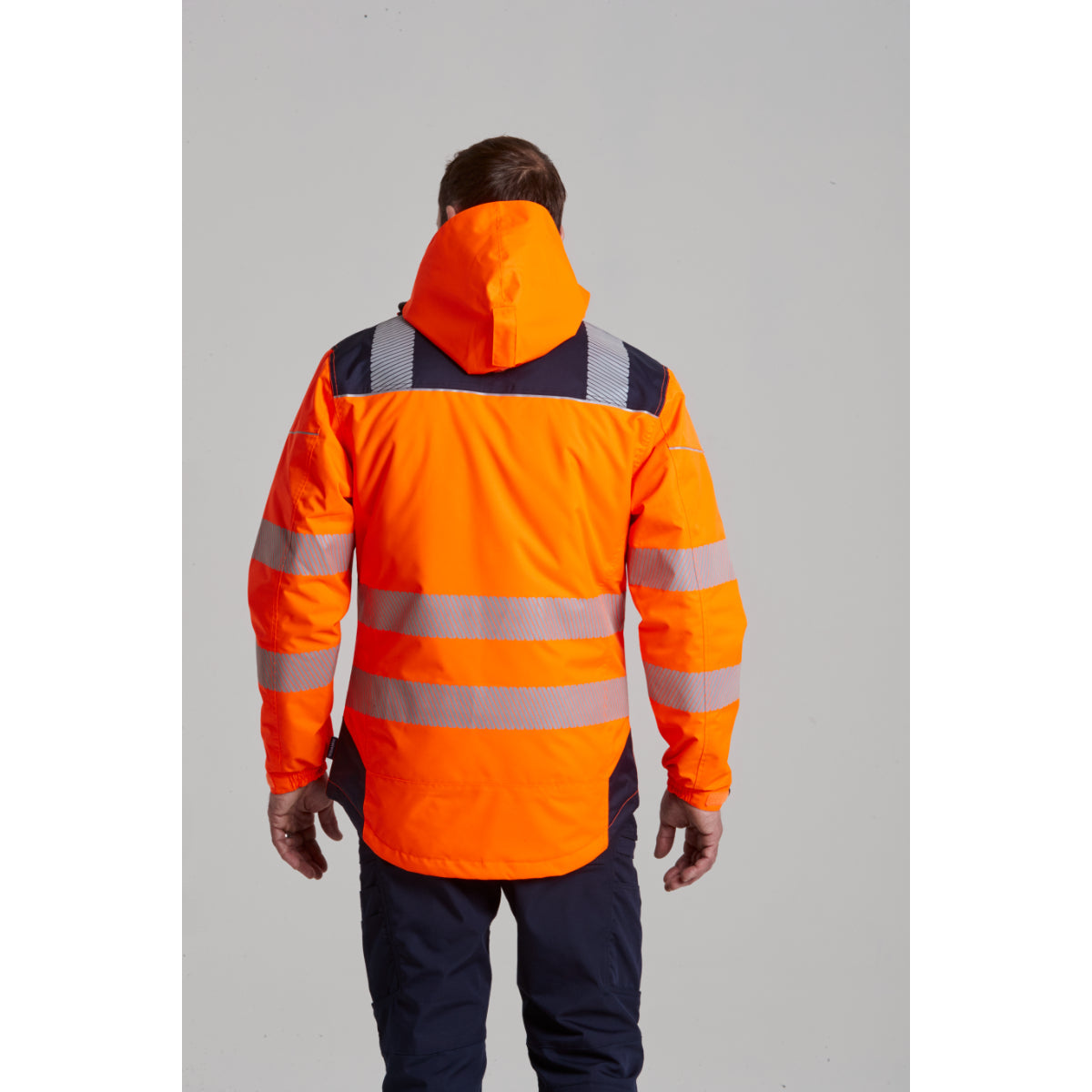 Rear view of a worker in the Portwest KX3 ripstop trousers, showing the pocket design
