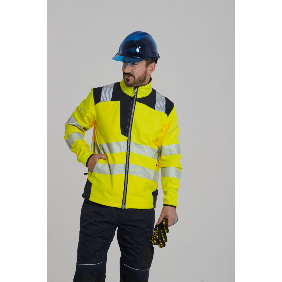 Worker in Portwest Softshell and safety helmet looking sideways.