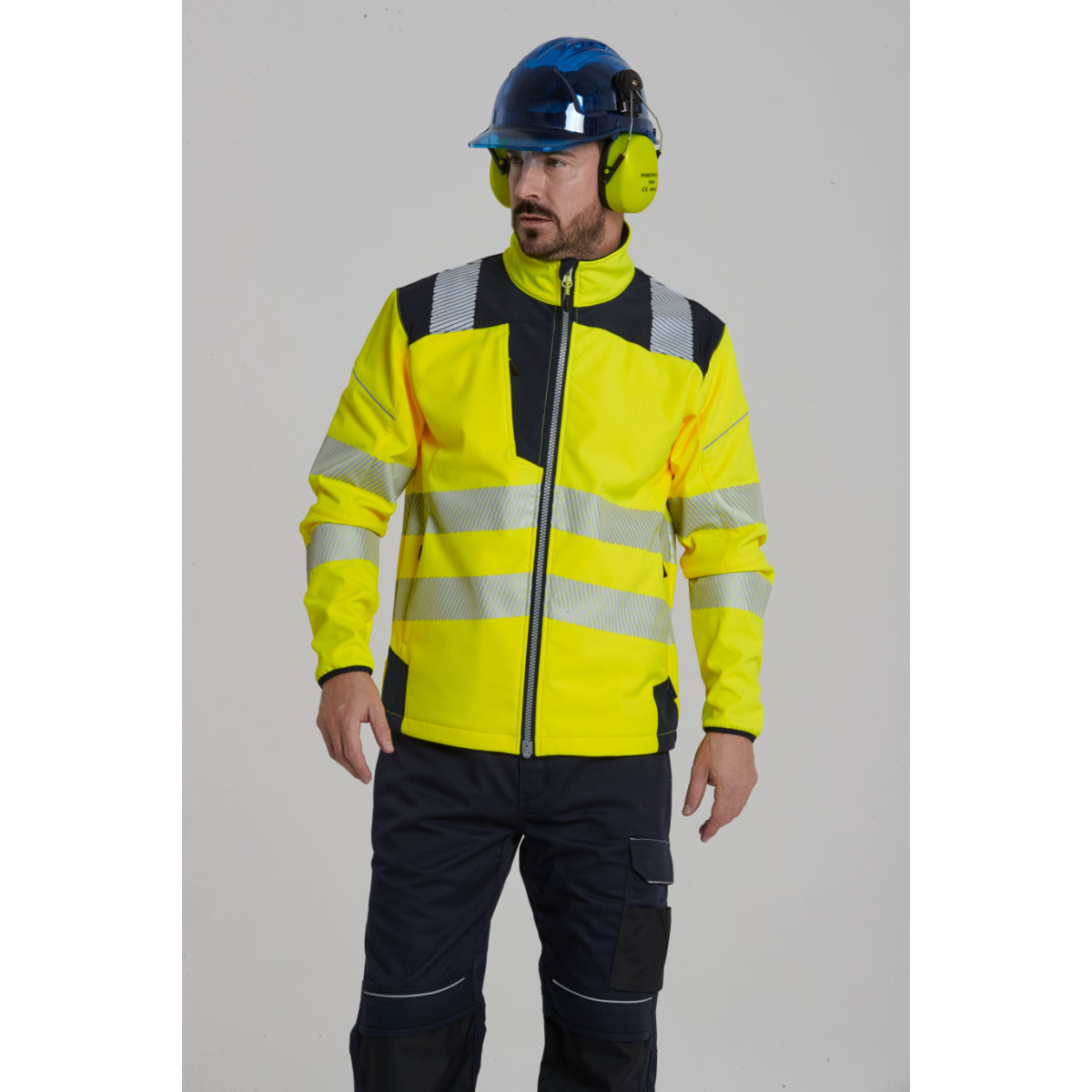 Worker operating machinery wearing a Portwest Hi-Vis jacket.