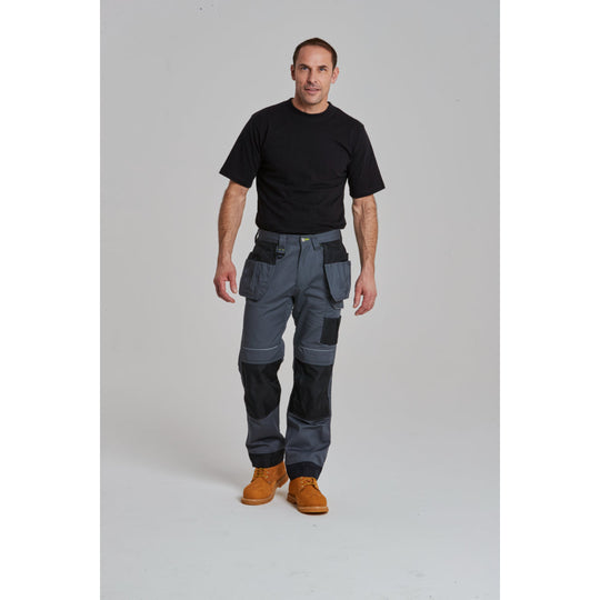 Worker in a professional setting wearing the black Portwest PW3 holster work trousers