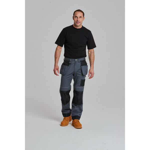 Worker in a professional setting wearing the black Portwest PW3 holster work trousers