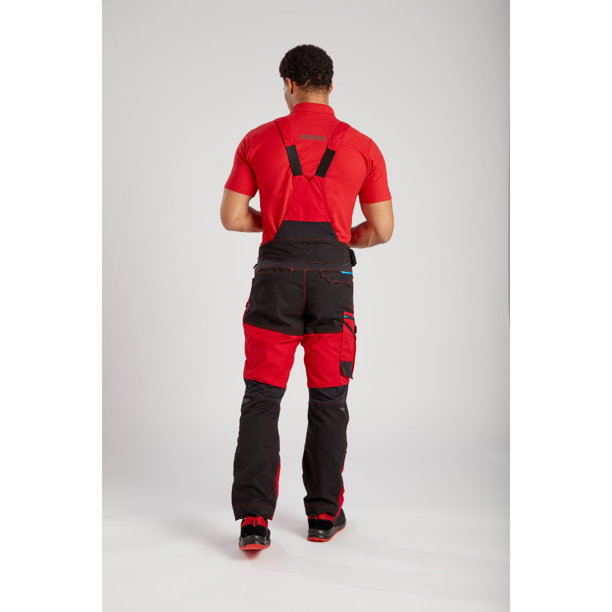 Worker equipped with Portwest WX3 Bib and Brace (T704) and other gear for a complete look.