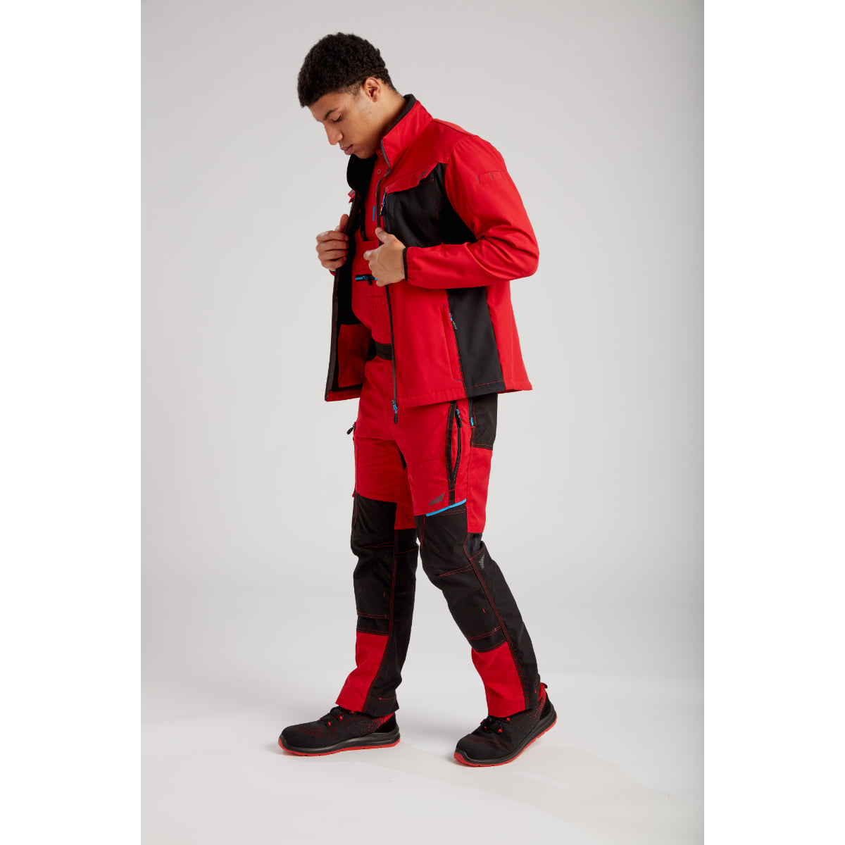 A worker in profile wearing the full Portwest WX3 workwear collection.