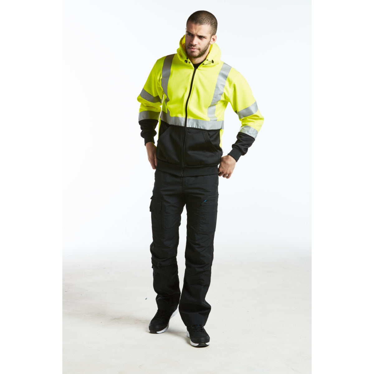 Worker wearing the Portwest KX3 ripstop trousers and a long-sleeved base layer for a layered work outfit.