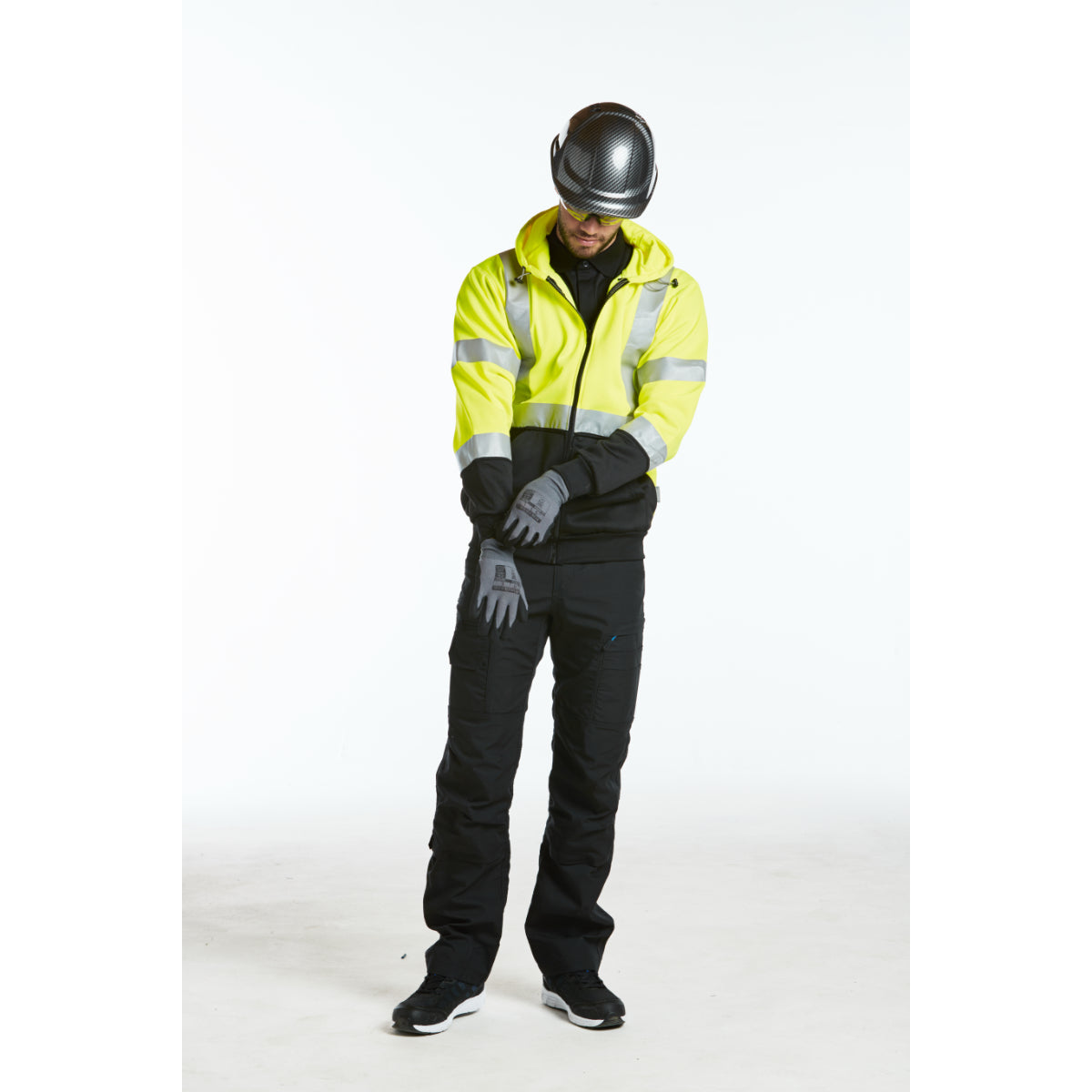 A person in Portwest gear, including Dermiflex Aqua gloves, in the rain.