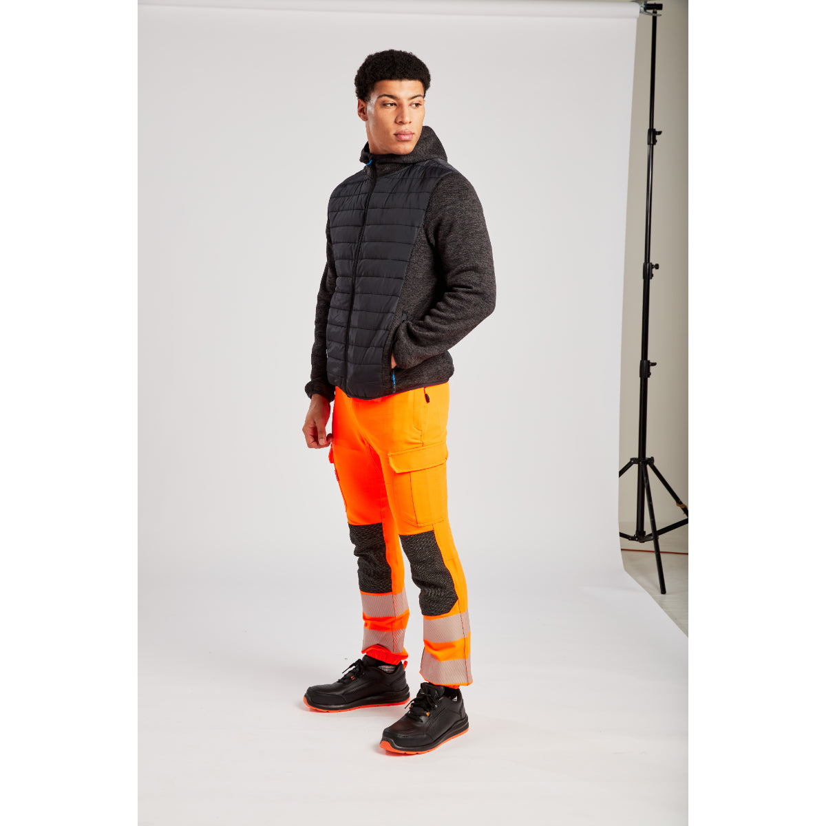 Angled view of a worker in the Portwest Hybrid Baffle Jacket.