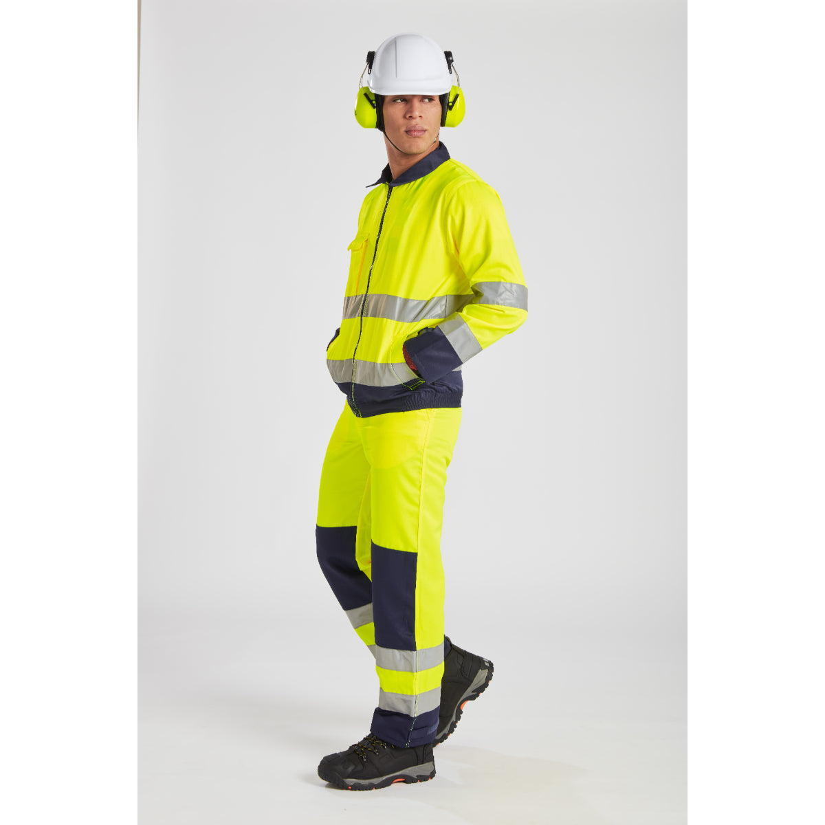 Industrial workers wearing Portwest PPE including coveralls, gloves, and helmets