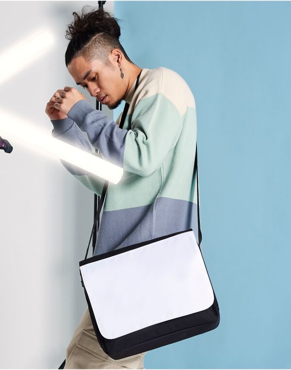Angled view of the Bagbase Sublimation Messenger Bag, showing its adjustable shoulder strap and side profile.