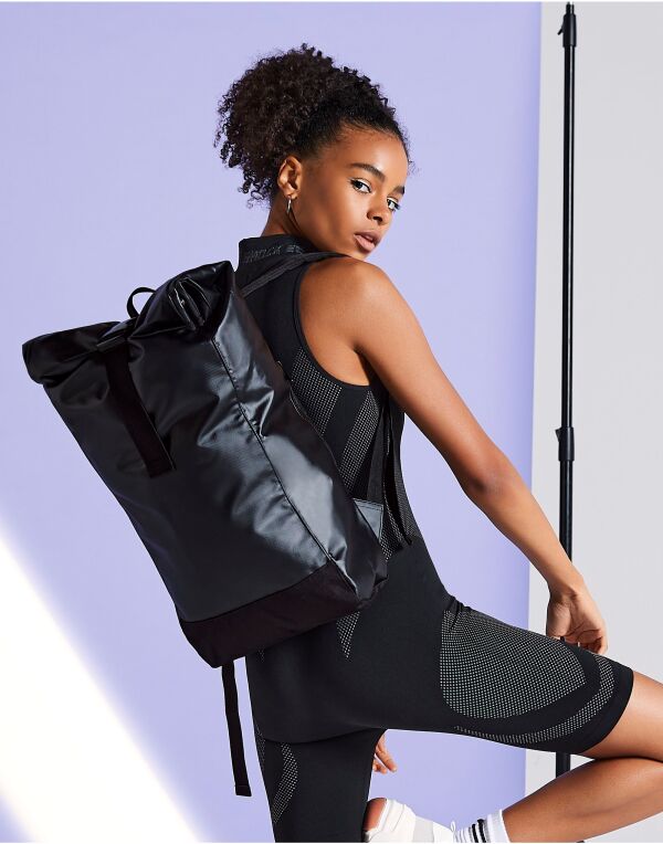 Person wearing the black tarp roll-top backpack.