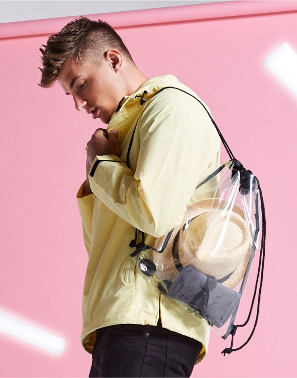 Angled view of the Bagbase Clear Gymsac with black trim and drawstrings, showing its contents.