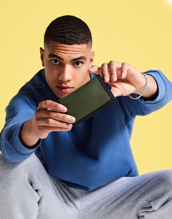 A person opening the soft grey matte PU mini accessory case.