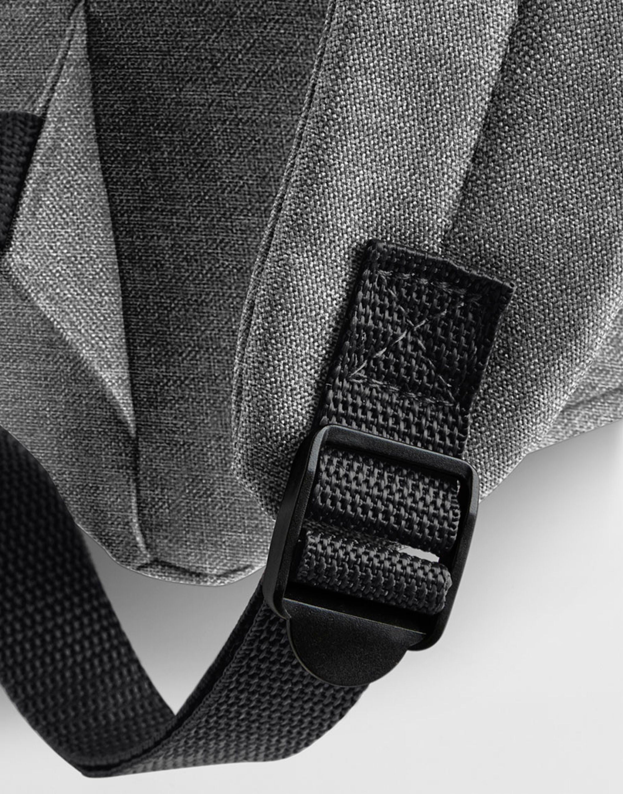 Detail of the adjustable shoulder strap on a black retro bag.