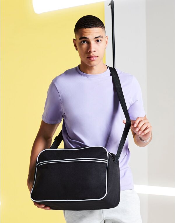 Person carrying the grey urban camo barrel bag.