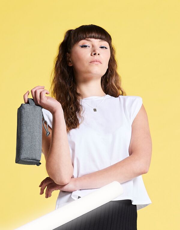 A collection of Bagbase Essential Pencil Cases in black, navy, red, and royal blue.