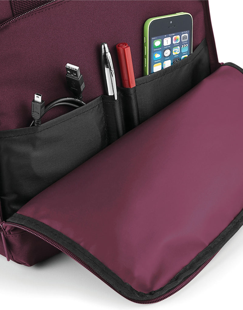 A red Bagbase Twin-Handle Backpack shown laid flat.