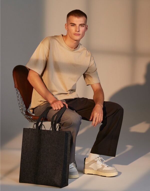 Angled view of the light grey marl Bagbase Felt Tote Bag, showcasing its chic and compact design.