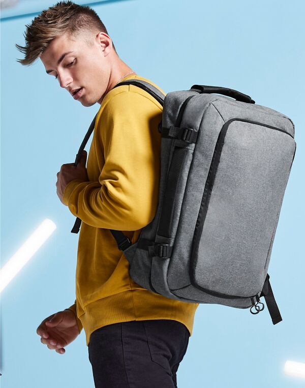 Angled shot of the Bagbase Escape Carry-On Backpack, showing its side compression straps and carry handle.