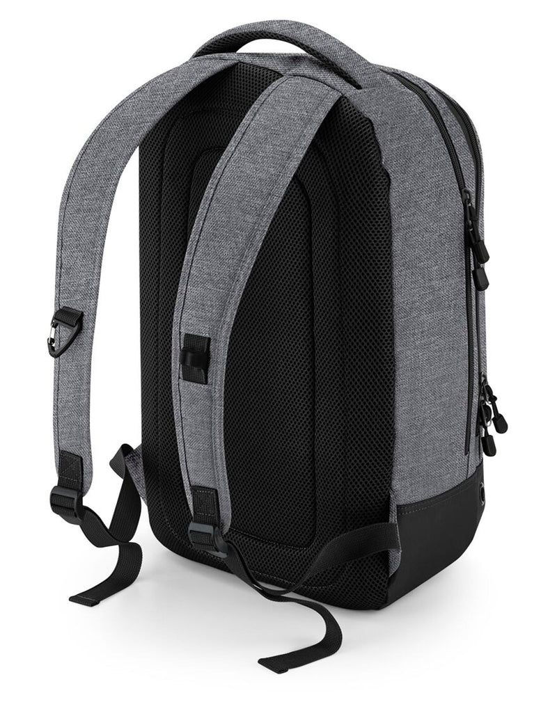 A person wearing the black Bagbase Athleisure Sports Backpack to demonstrate its ergonomic fit.