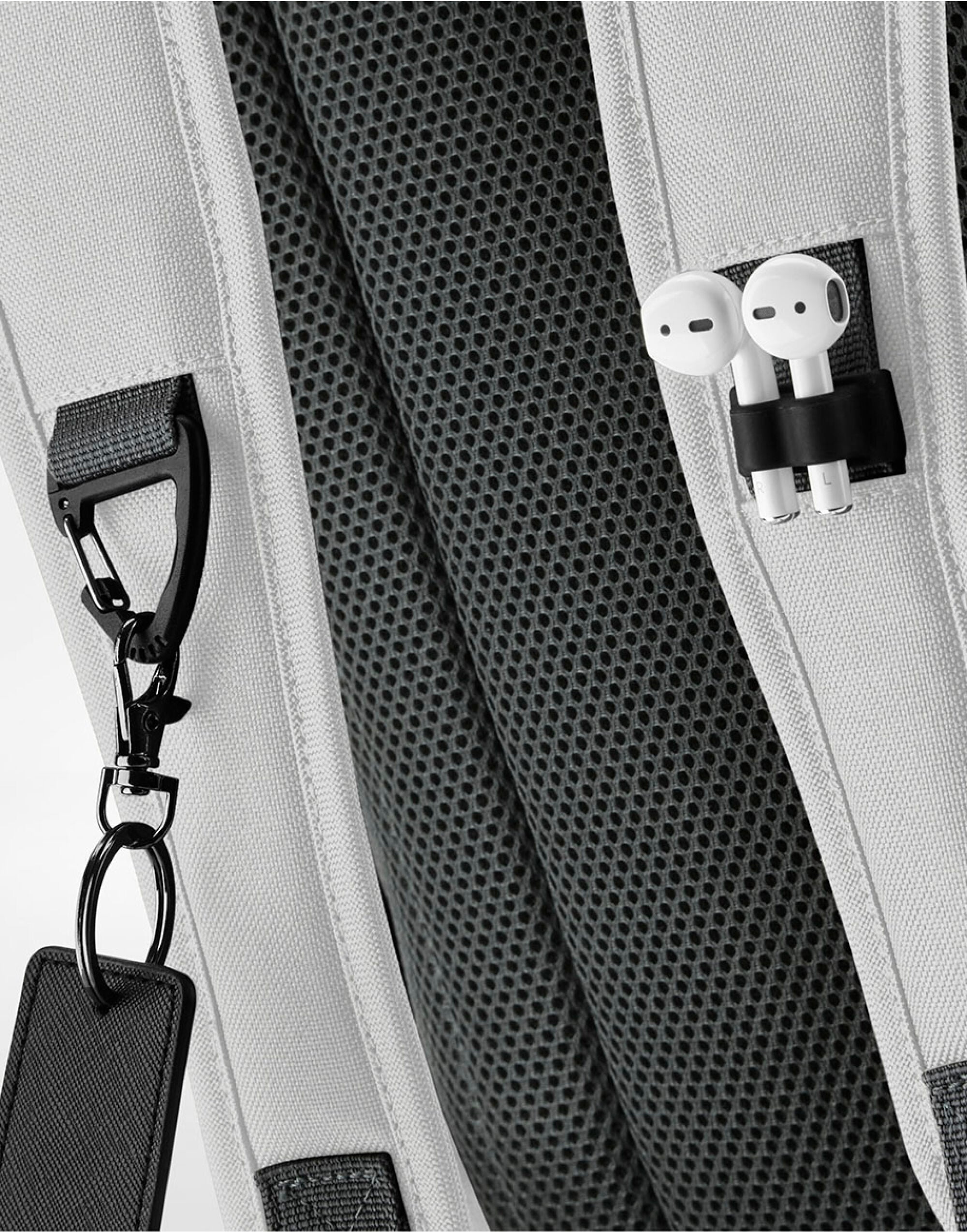 Angled side view of the black Bagbase Athleisure Sports Backpack, showing its full feature set.