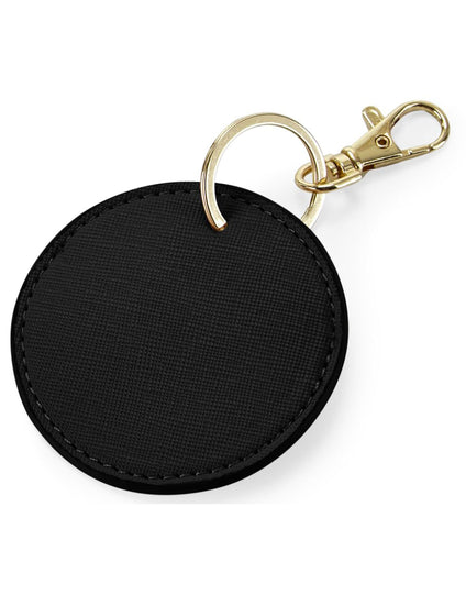 The Bagbase Boutique Circular Key Clip in black Saffiano faux leather with gold hardware.