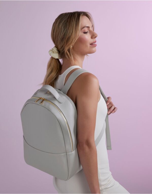 Lifestyle view of a person wearing the black Bagbase boutique backpack.