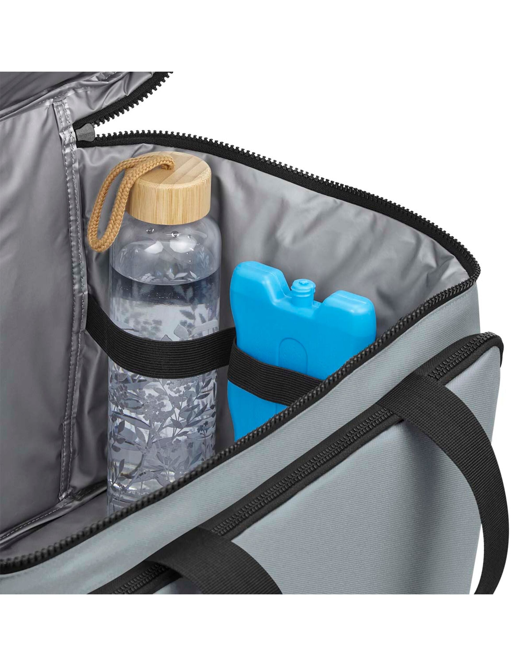 Side angle of the Bagbase Heritage backpack, showing the magnetic closure side pockets and padded back panel.