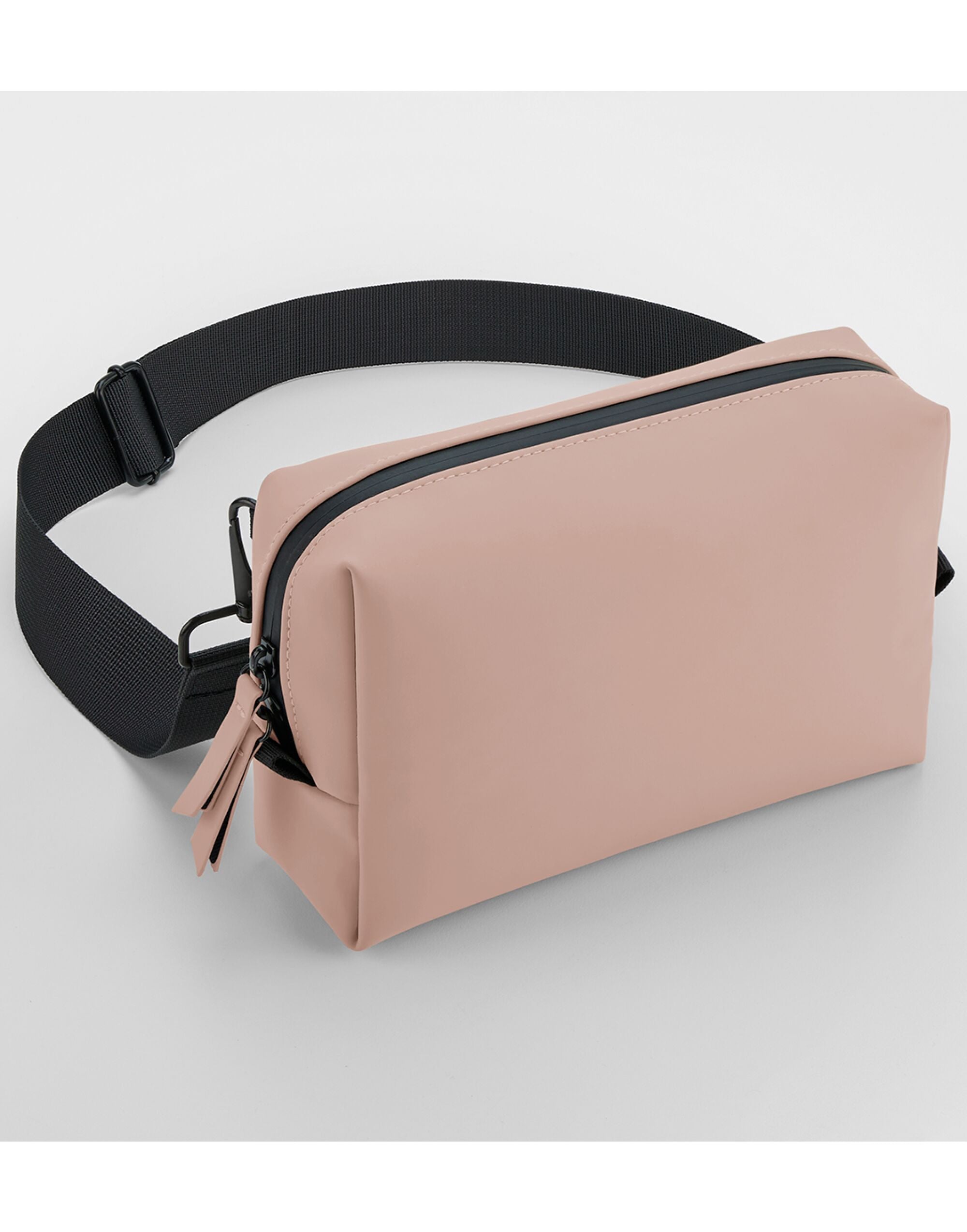 Angled view of the pink matte PU cross body bag.