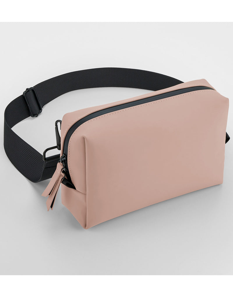 Angled view of the pink matte PU cross body bag.