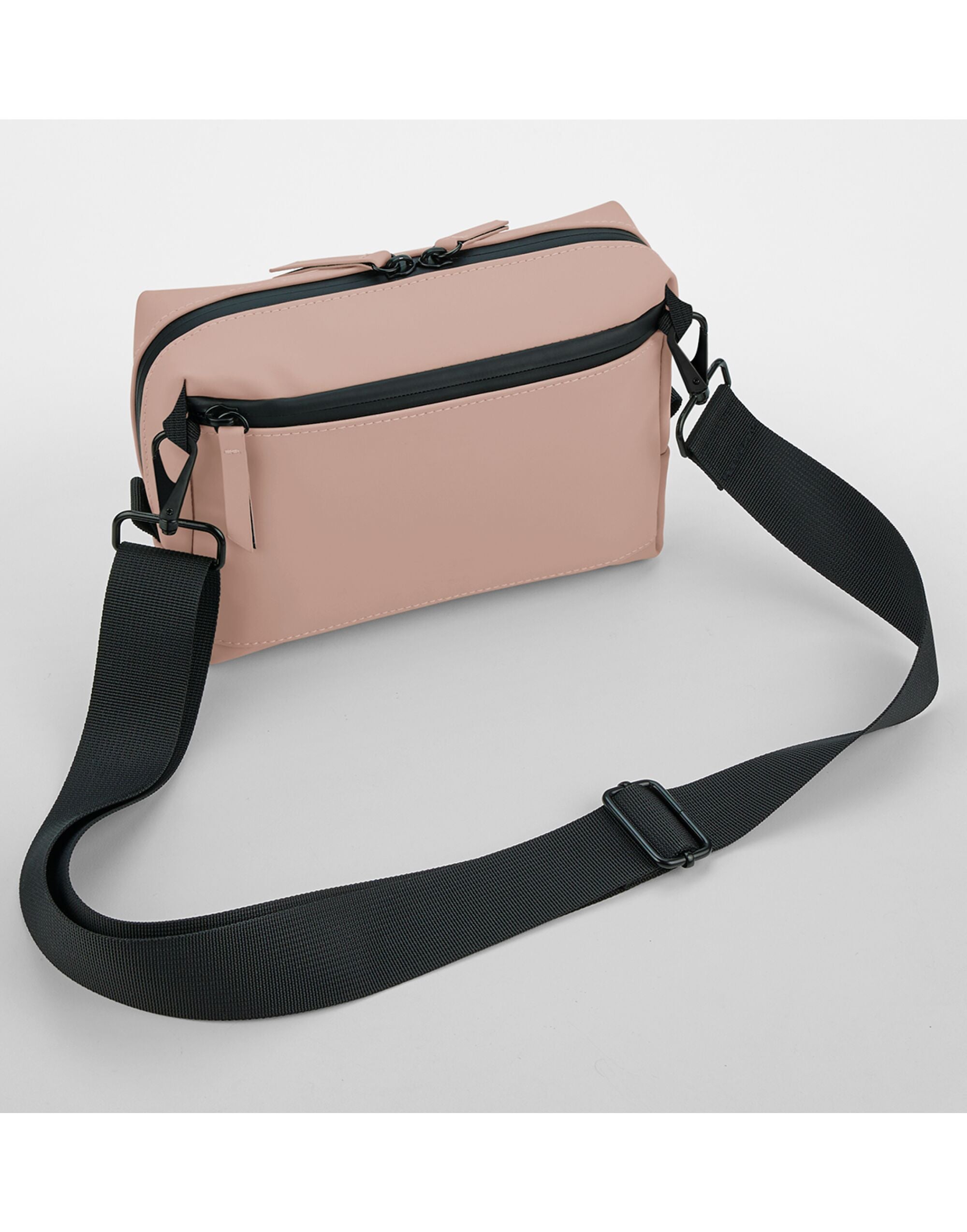 Angled view of the pink matte PU cross body bag.