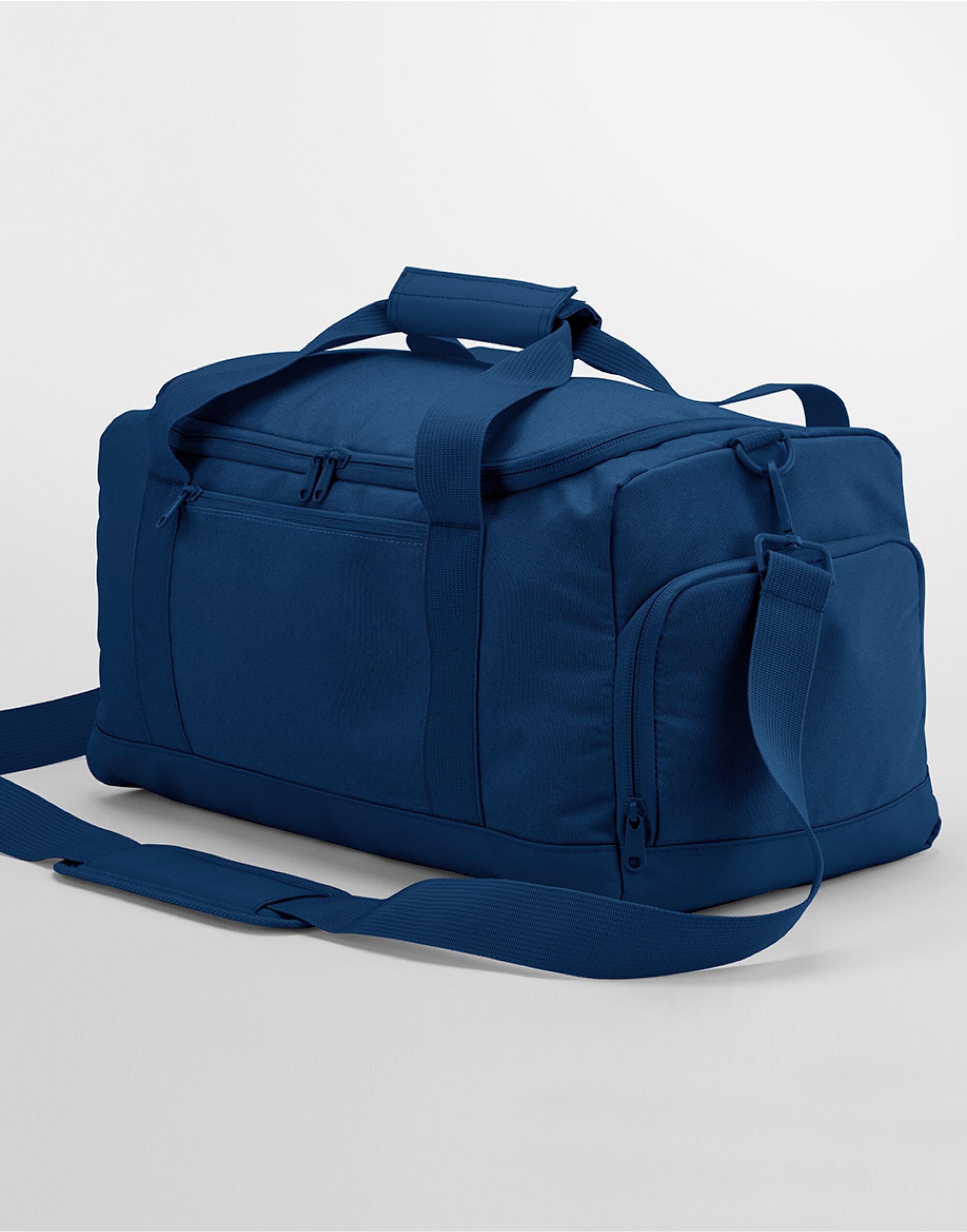 Angled view of the navy Bagbase Small Training Holdall, showcasing its main compartment and front pocket.