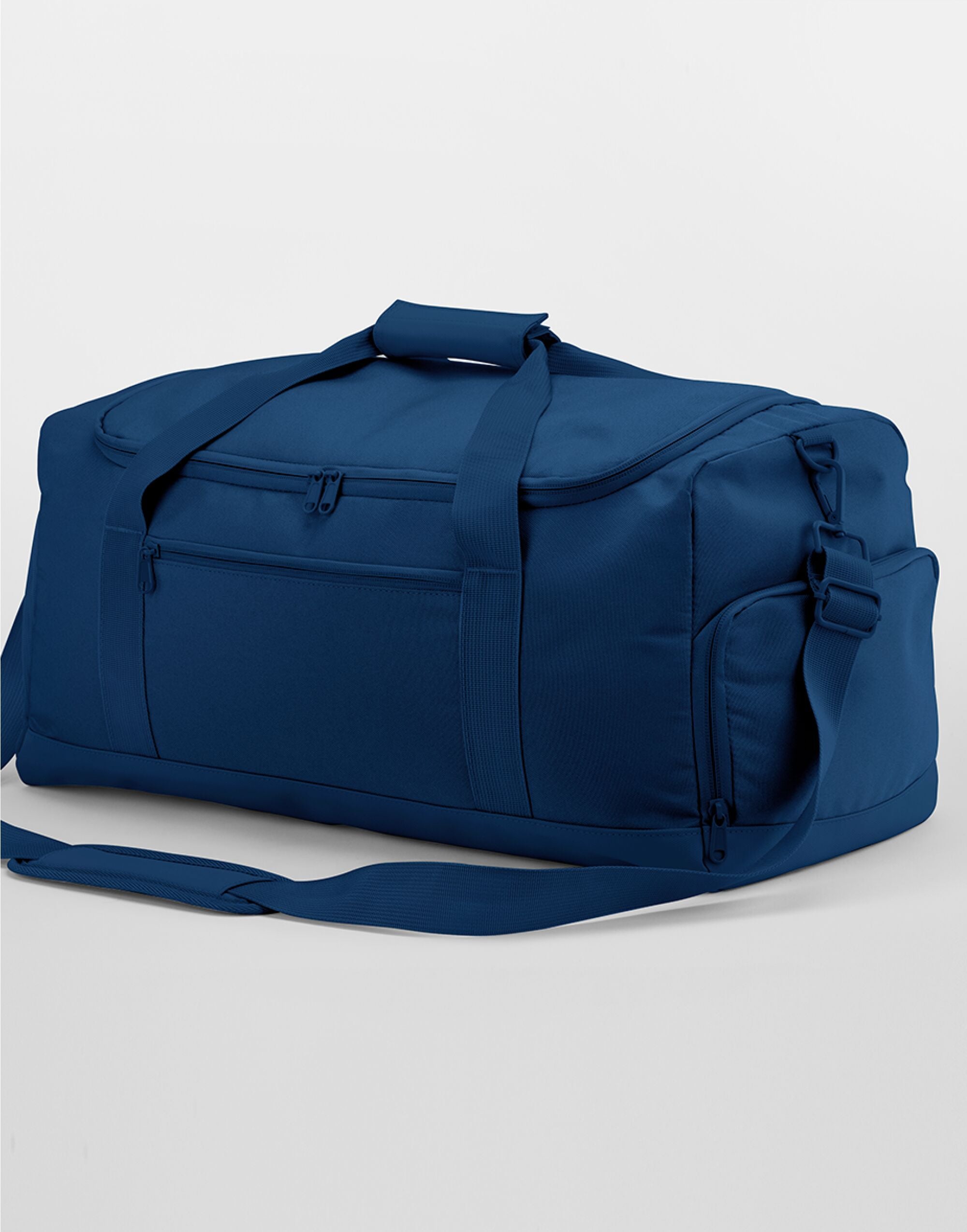 Angled view of the navy Bagbase Medium Training Holdall, with its detachable shoulder strap visible.