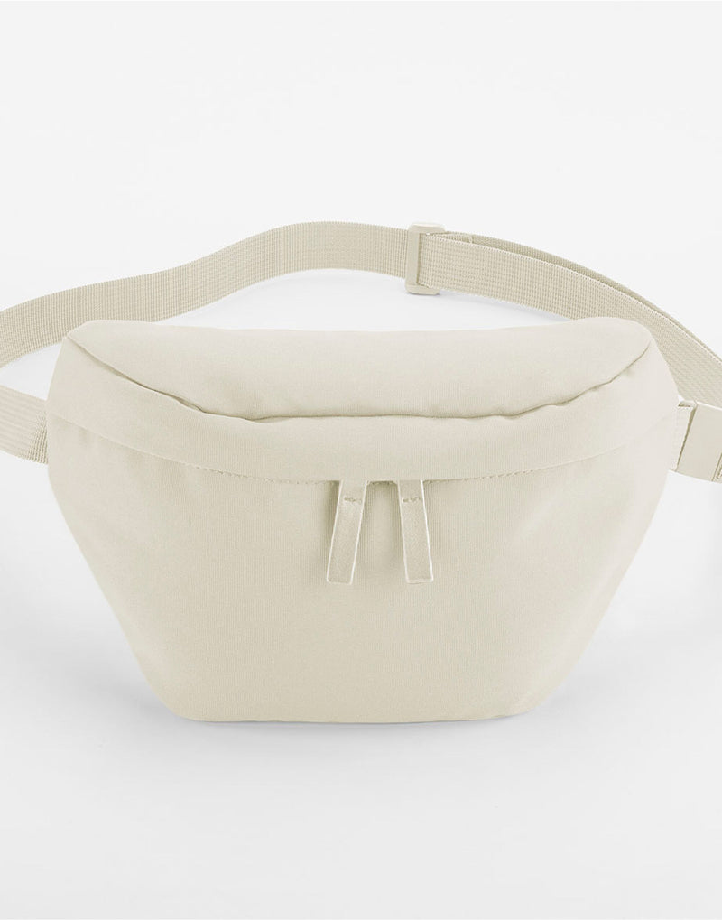 Angled view of the off-white Bagbase Simplicity Waistpack, showcasing its faux leather accents.
