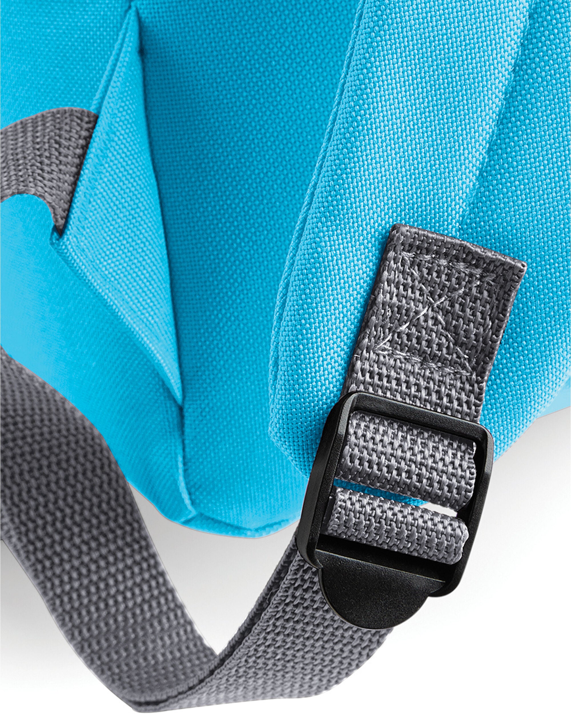 Side profile of a navy Bagbase Original Fashion Backpack.