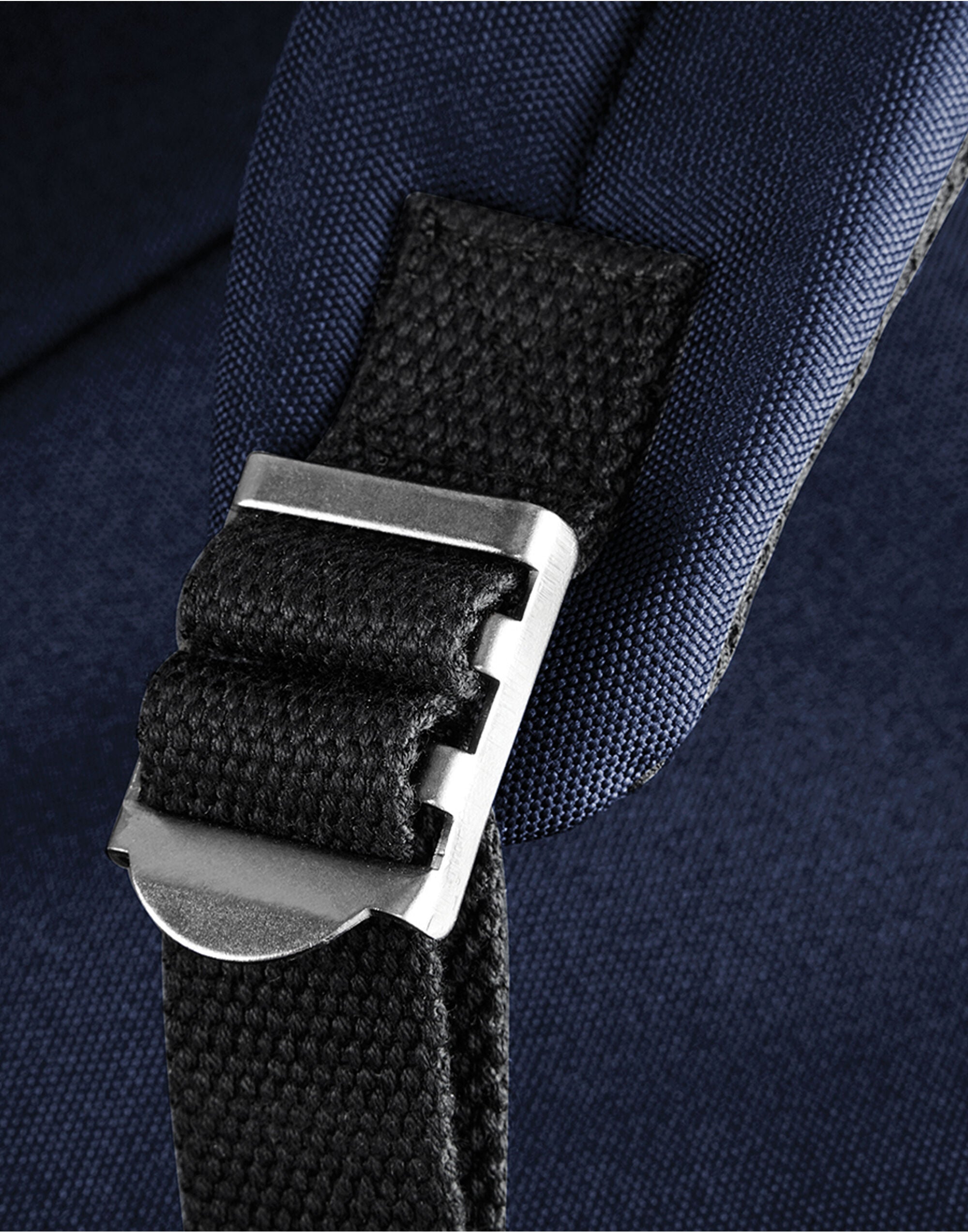 A navy and pink patterned adjustable bag strap.