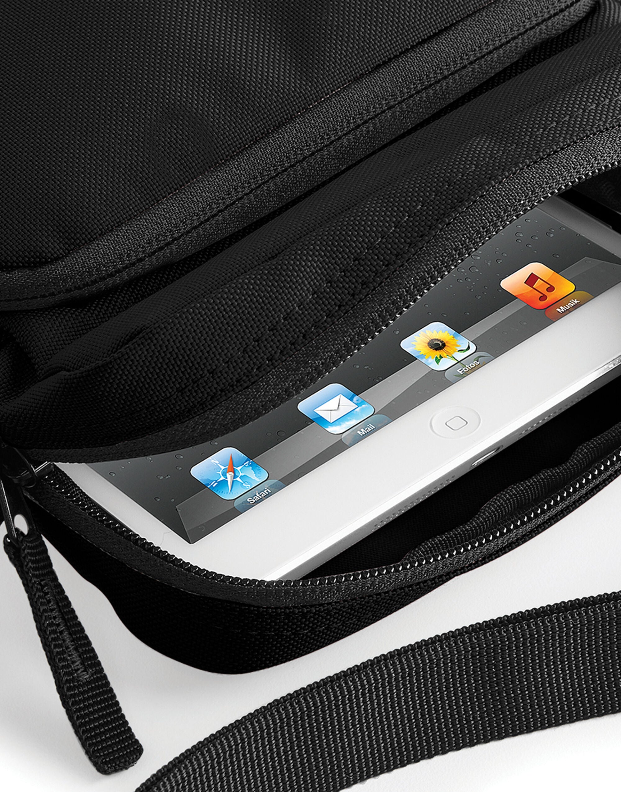 Close-up on the strap and hardware of the black across-body bag.