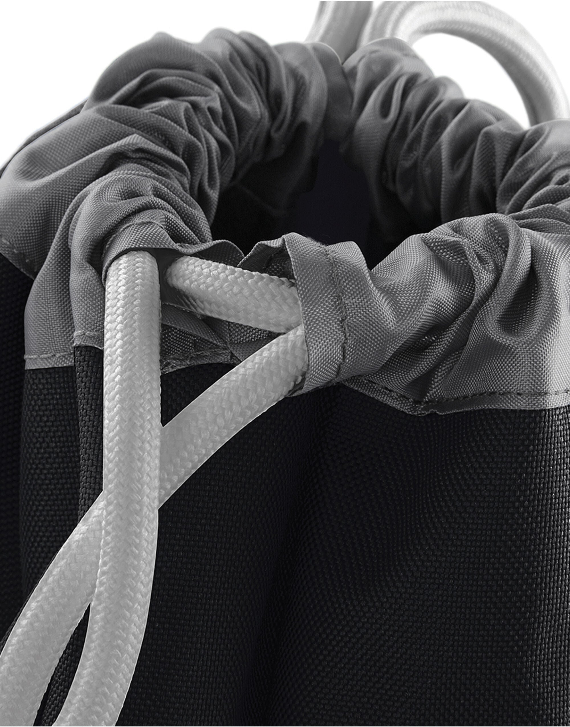 Detail shot of the zippered front pocket on the black Bagbase Athleisure Gymsac for secure, easy-access storage.