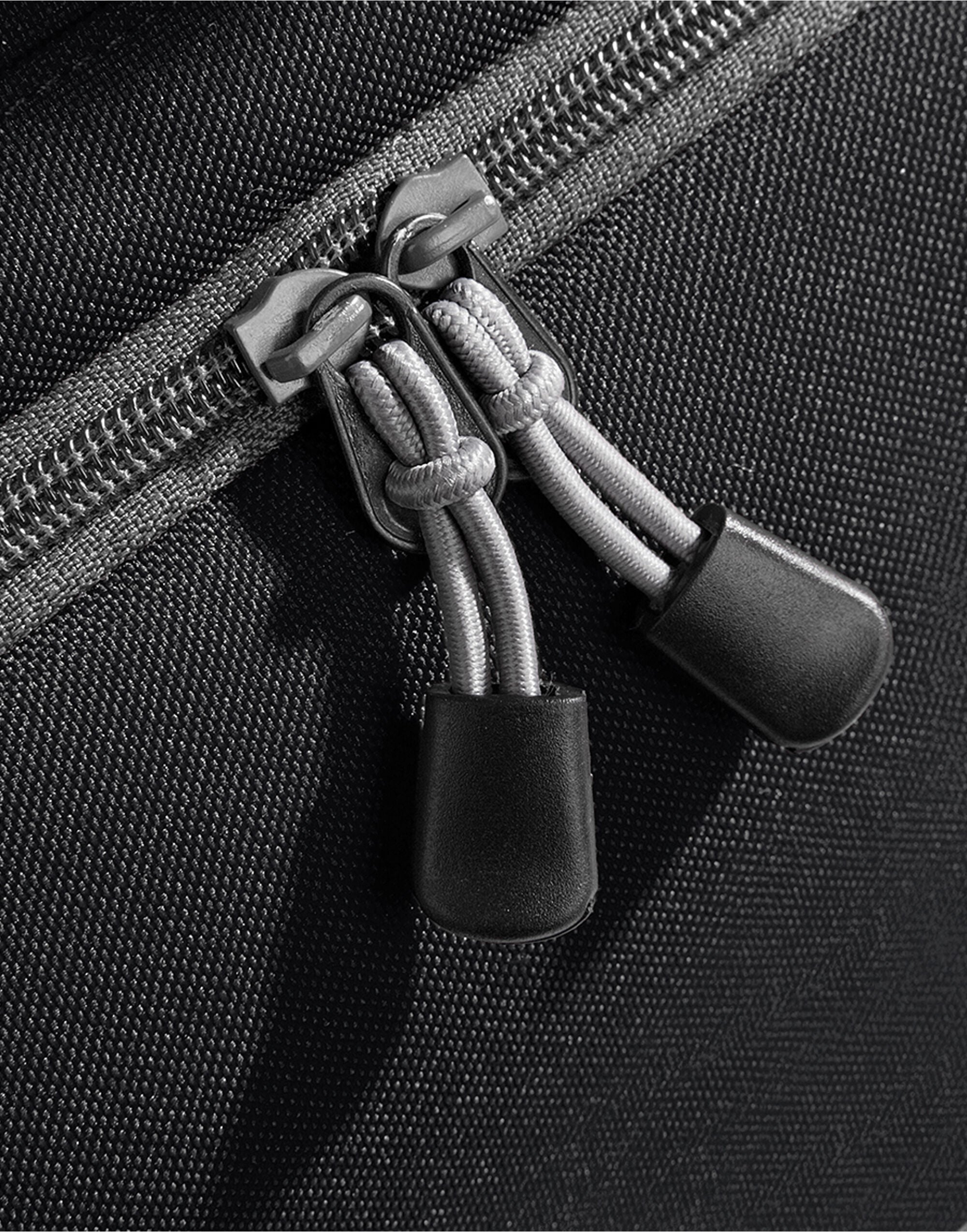 Close-up of the dual webbing carry handles with a padded wrap on the black Bagbase Athleisure Holdall.