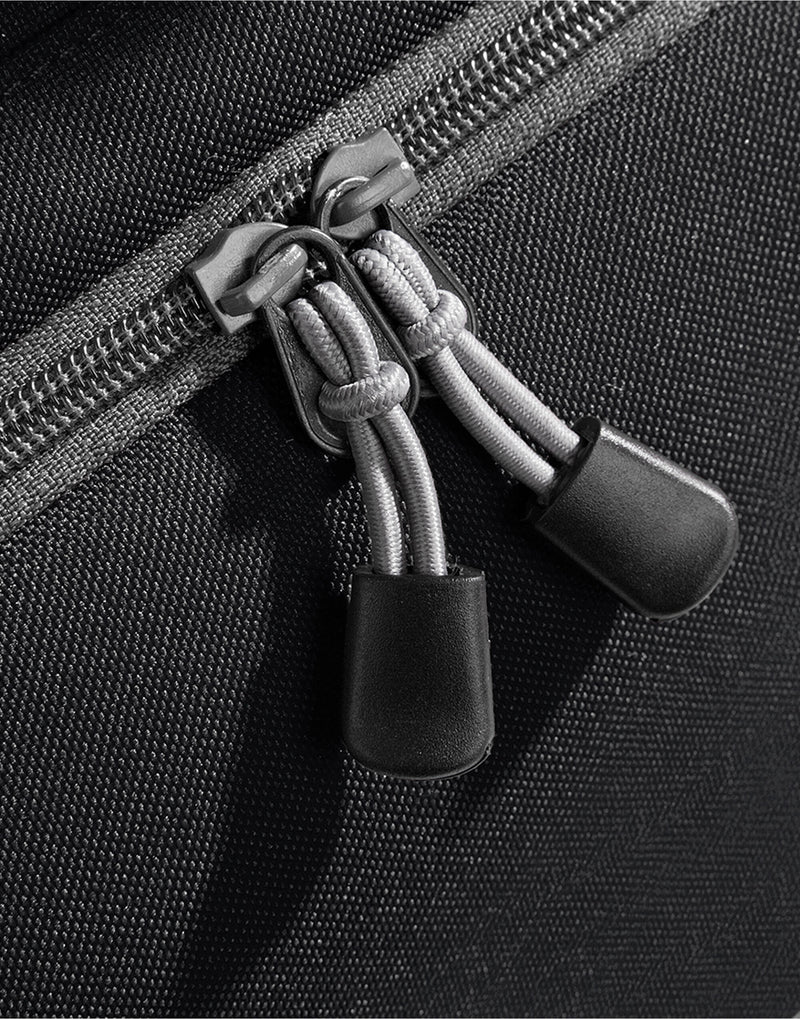 Close-up of the dual webbing carry handles with a padded wrap on the black Bagbase Athleisure Holdall.