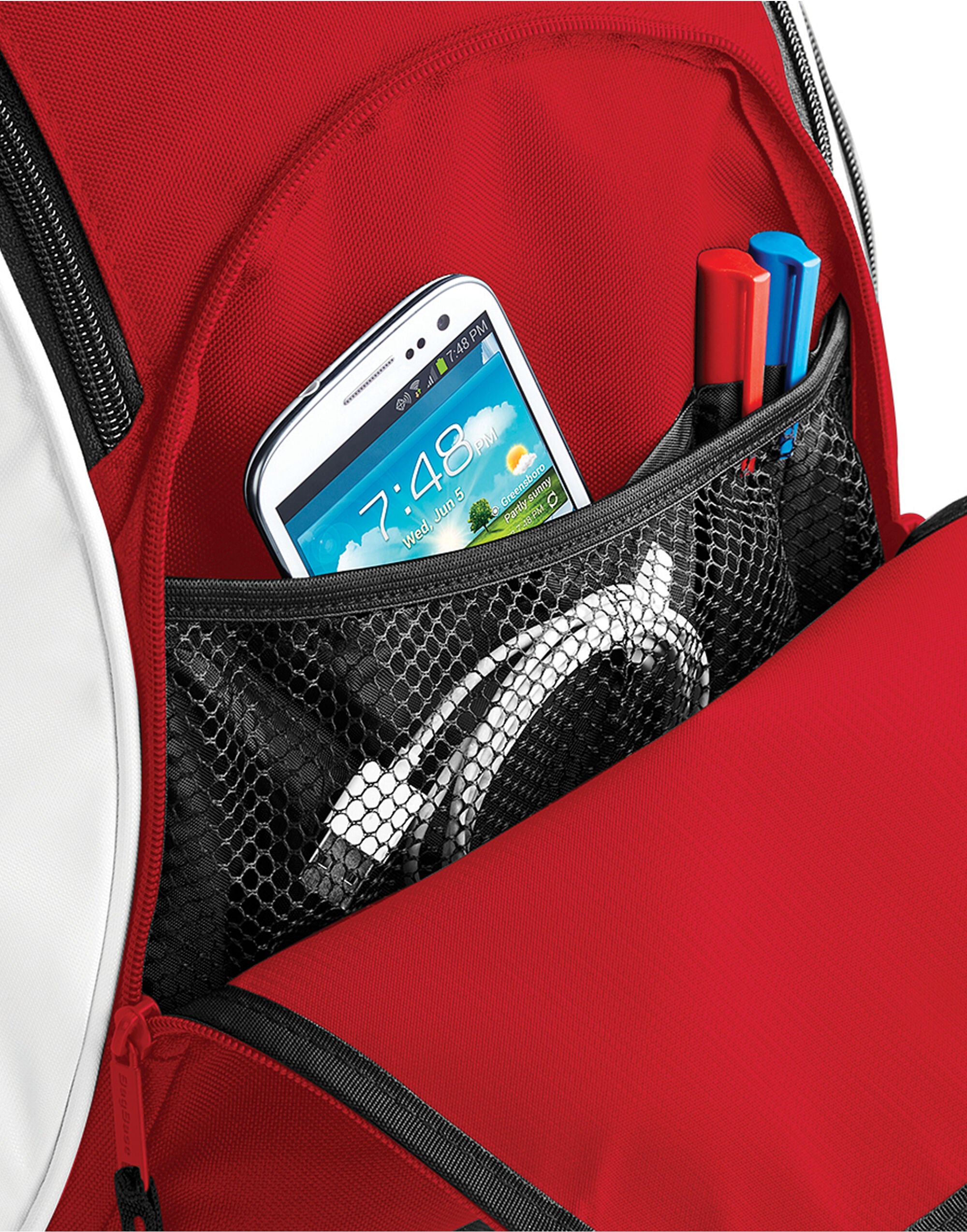 The white and black Bagbase Teamwear Backpack, shown from a dynamic side angle.