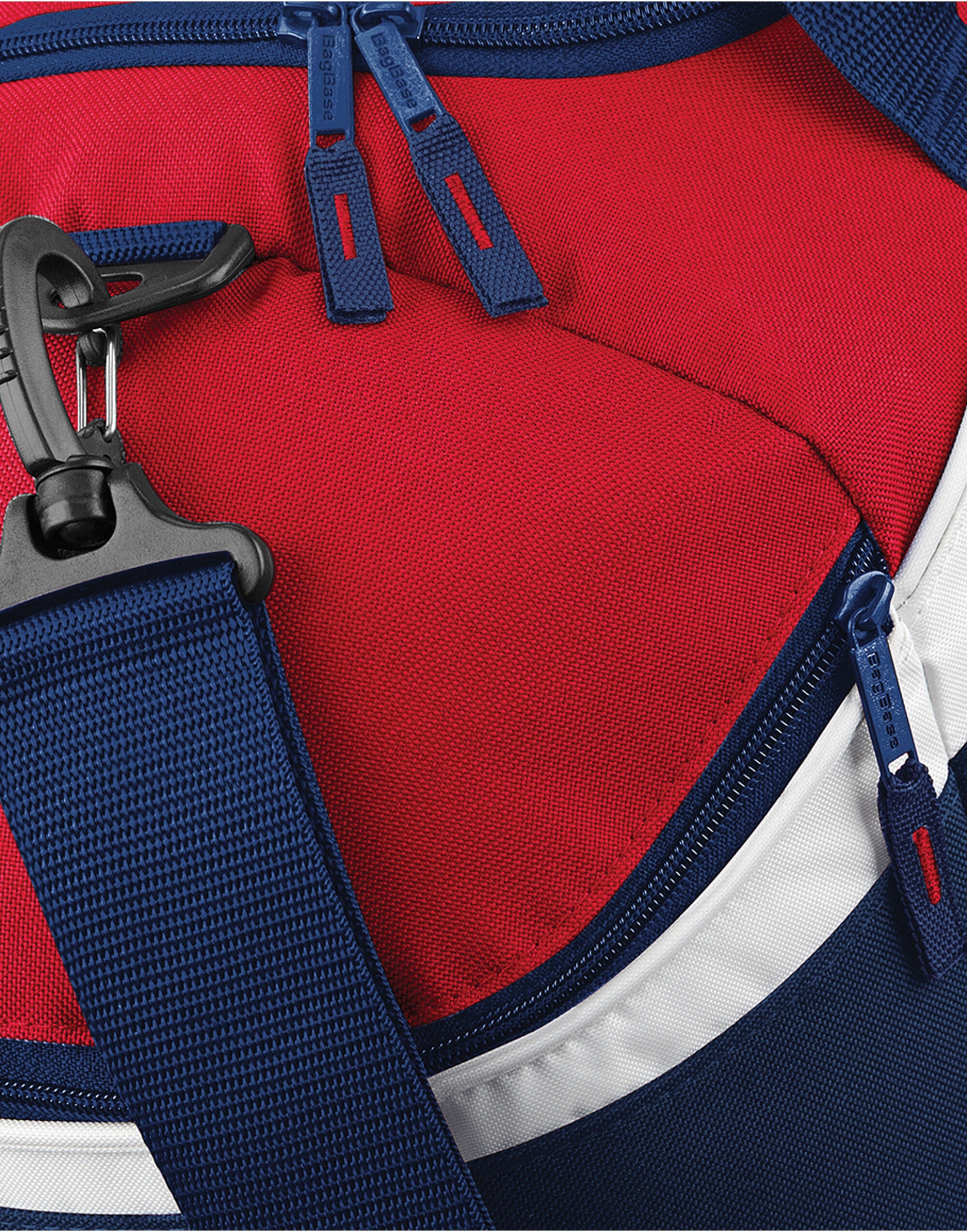 Angled side view of the royal blue Bagbase Teamwear Holdall, focusing on the end pocket.