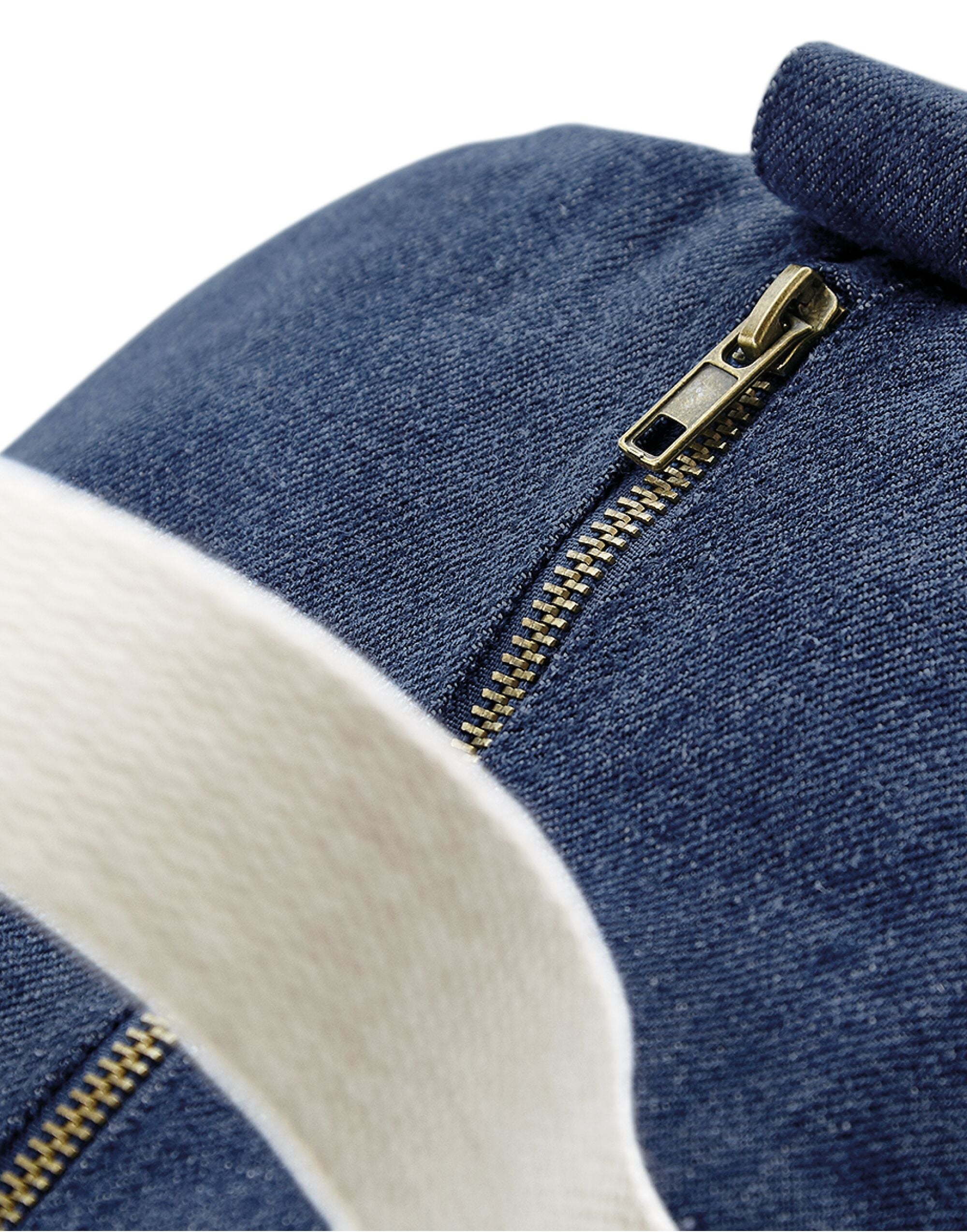 Side profile of the blue denim Bagbase Barrel Bag, showing the end of its main zippered compartment.
