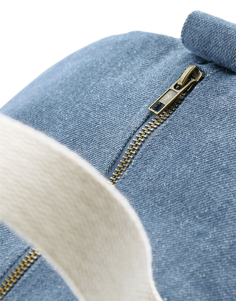 Close-up of the antique brass effect zippers and fittings on the stylish Bagbase Denim Barrel Bag.