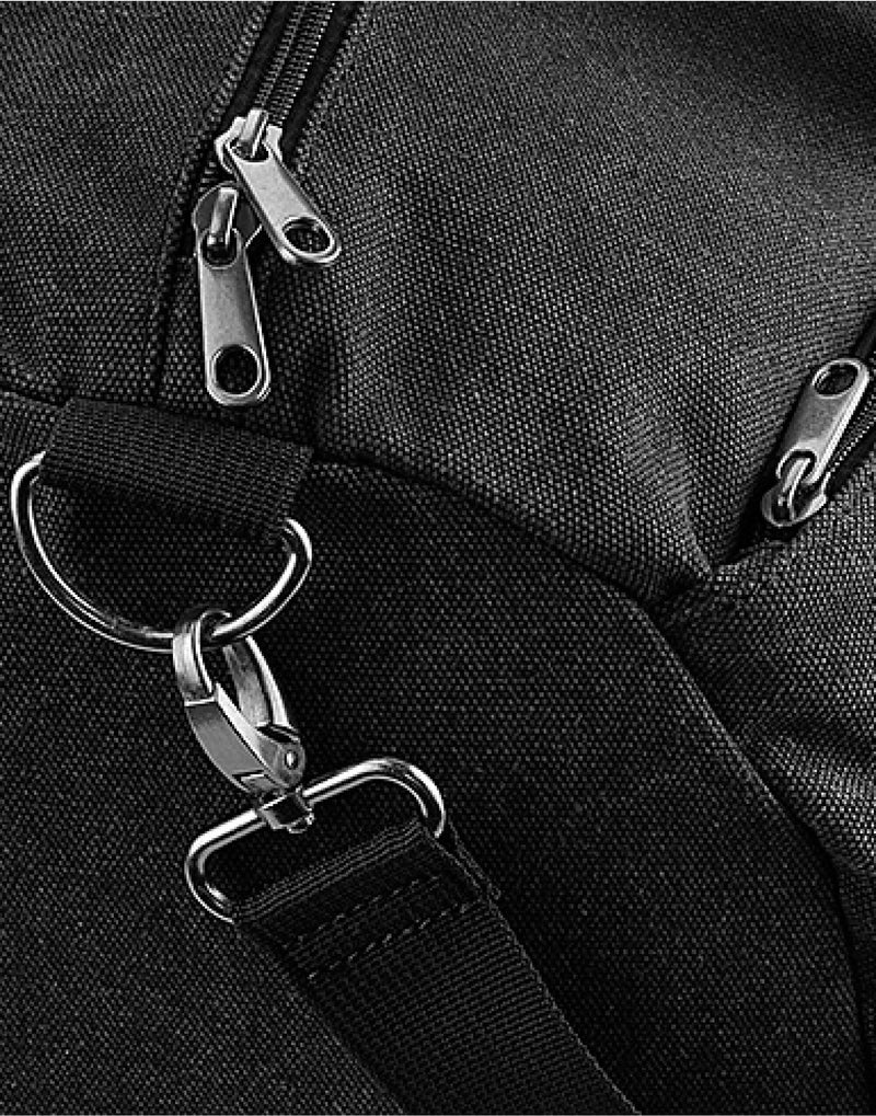 The navy Bagbase Vintage Canvas Barrel Bag, featuring a detachable, adjustable shoulder strap.