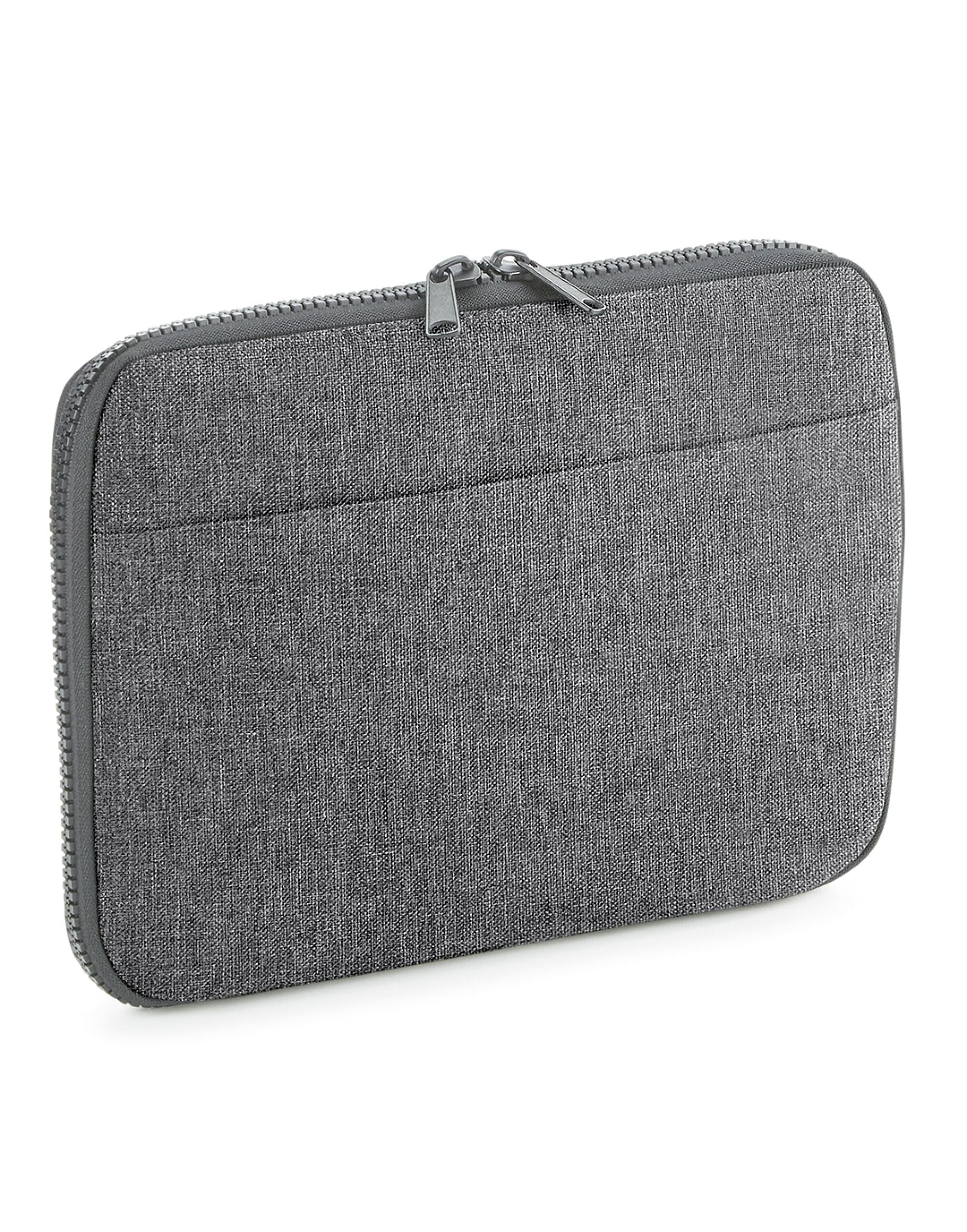 The black Bagbase Essential Tech Organiser filled with tech accessories to demonstrate its capacity.