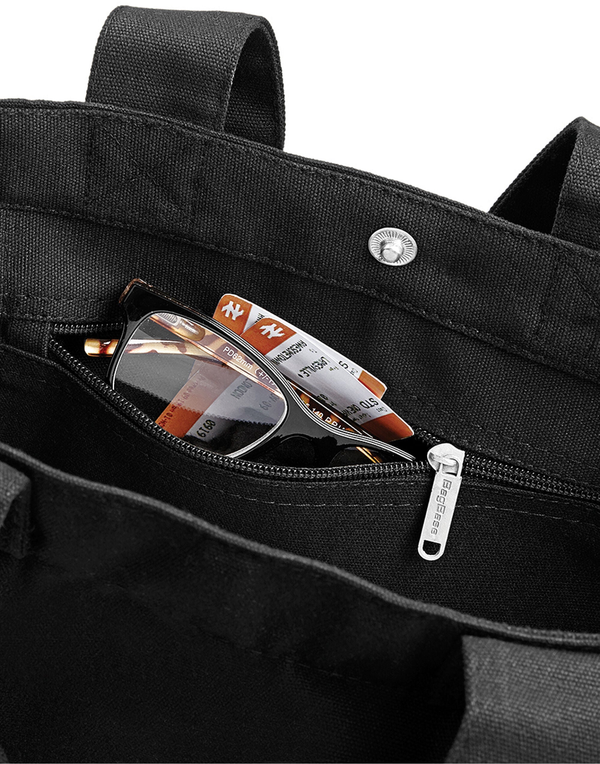 The natural canvas Bagbase Day Bag with its adjustable shoulder strap, perfect for everyday use.